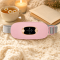 FemHeat warming massage belt on a cozy knit blanket